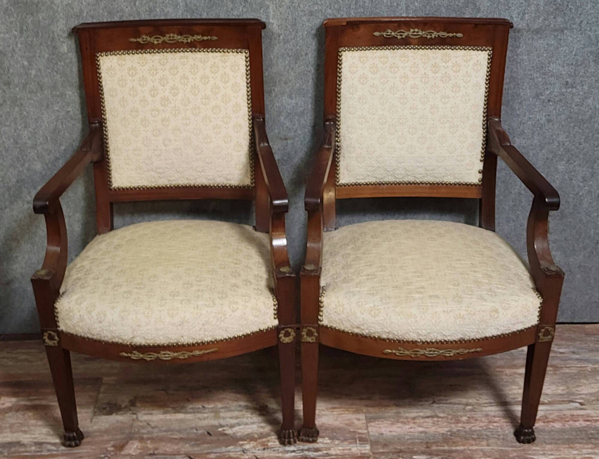 Pair of Empire period armchairs, in mahogany and gilded bronze.