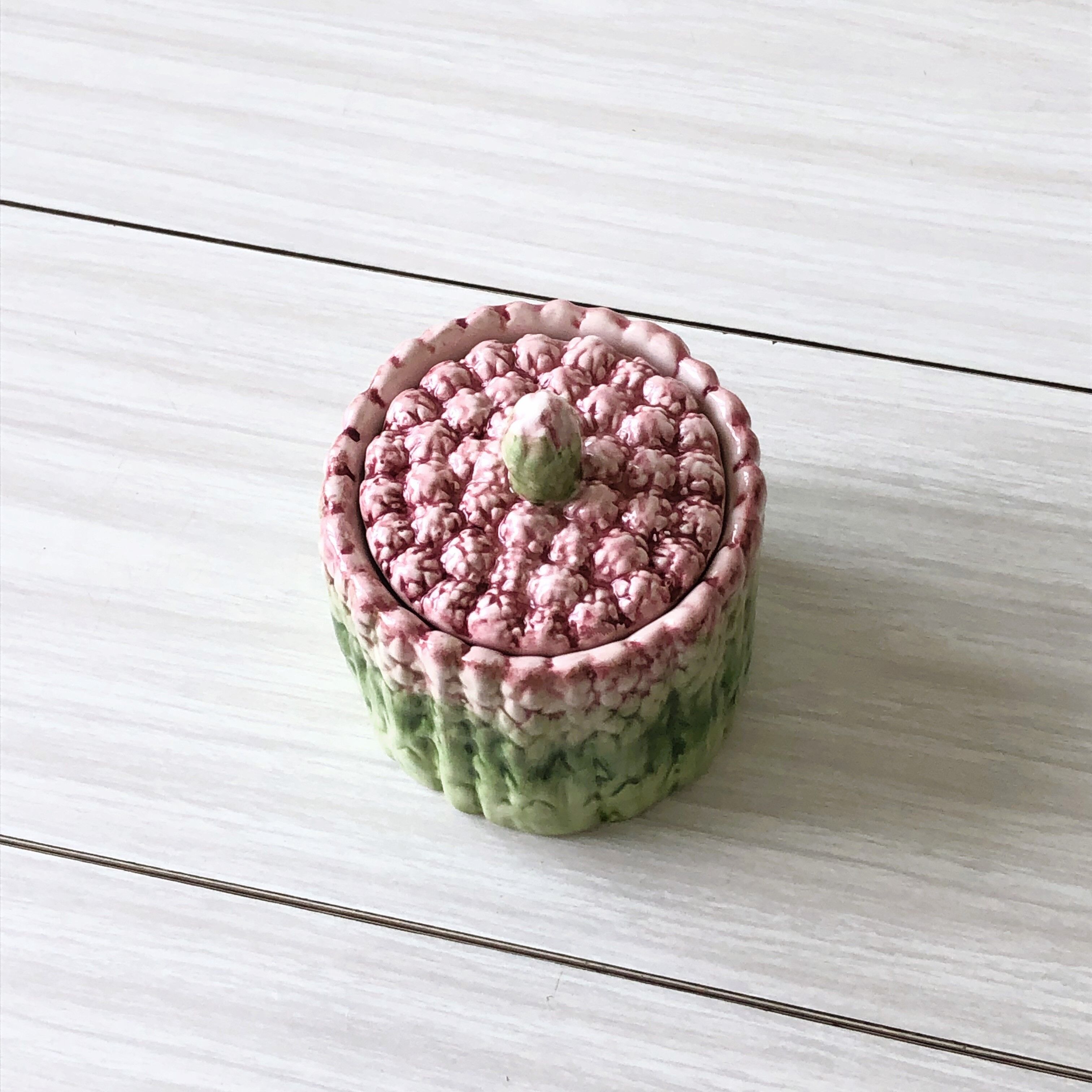 Old mustard pot and its slid in slurry decoration bunch of asparagus.