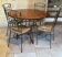 Table and four wrought iron and wood chairs.