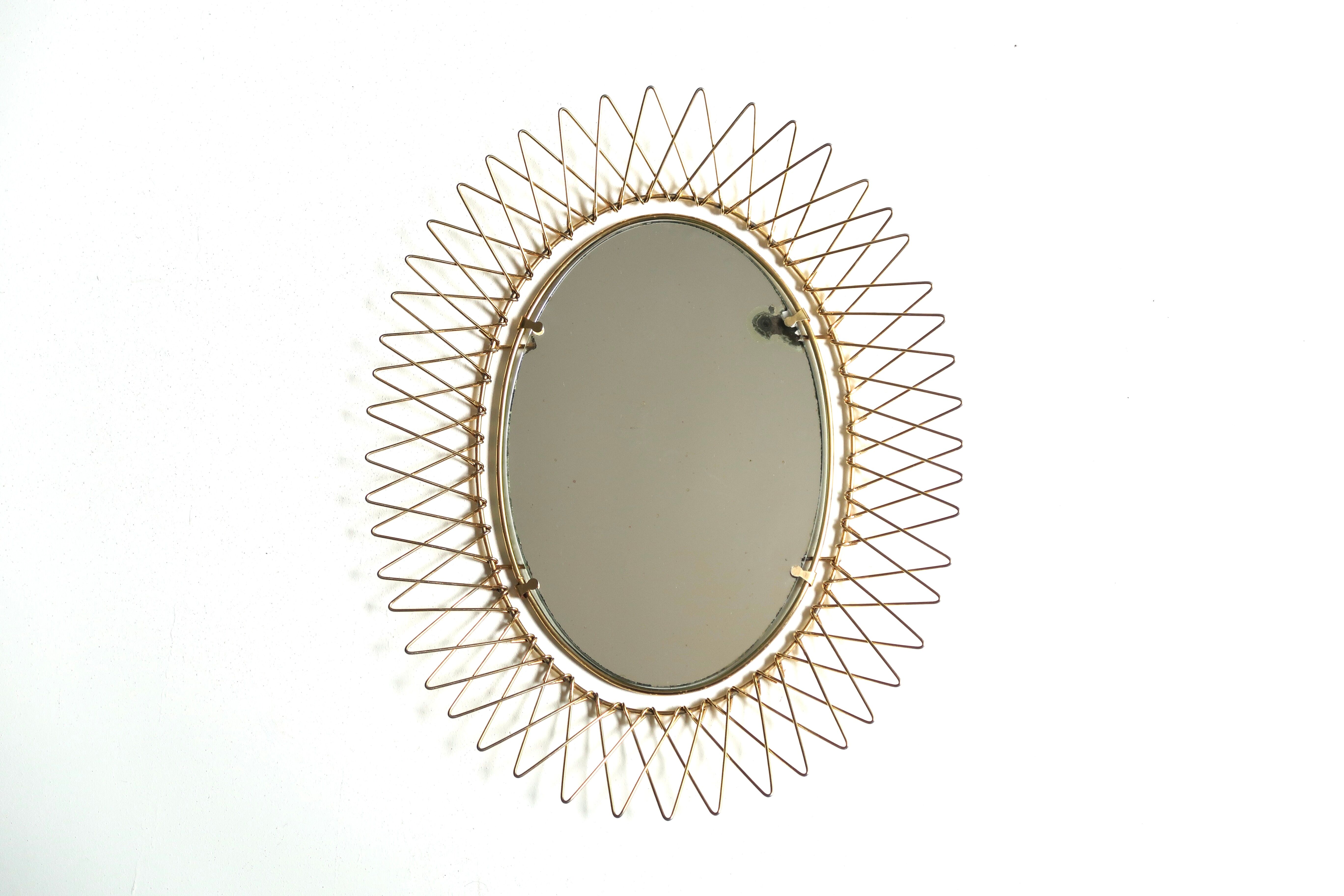 Oval golden sun mirror in metal, 1960s