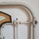 Cast-iron headboard and patinated white wood