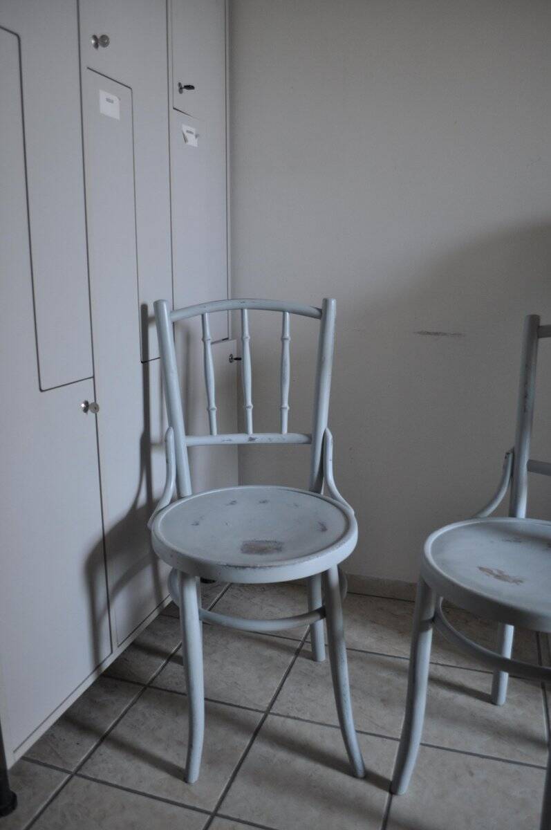 Pair of Lichtig bistro chairs in painted grey beech, pressed seat, circa 1900.