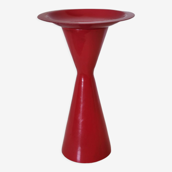 Vintage design candlestick in red metal in the shape of an hourglass