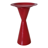 Vintage design candlestick in red metal in the shape of an hourglass
