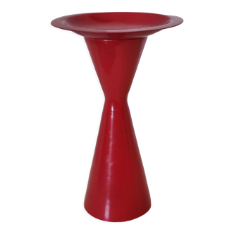 Vintage design candlestick in red metal in the shape of an hourglass