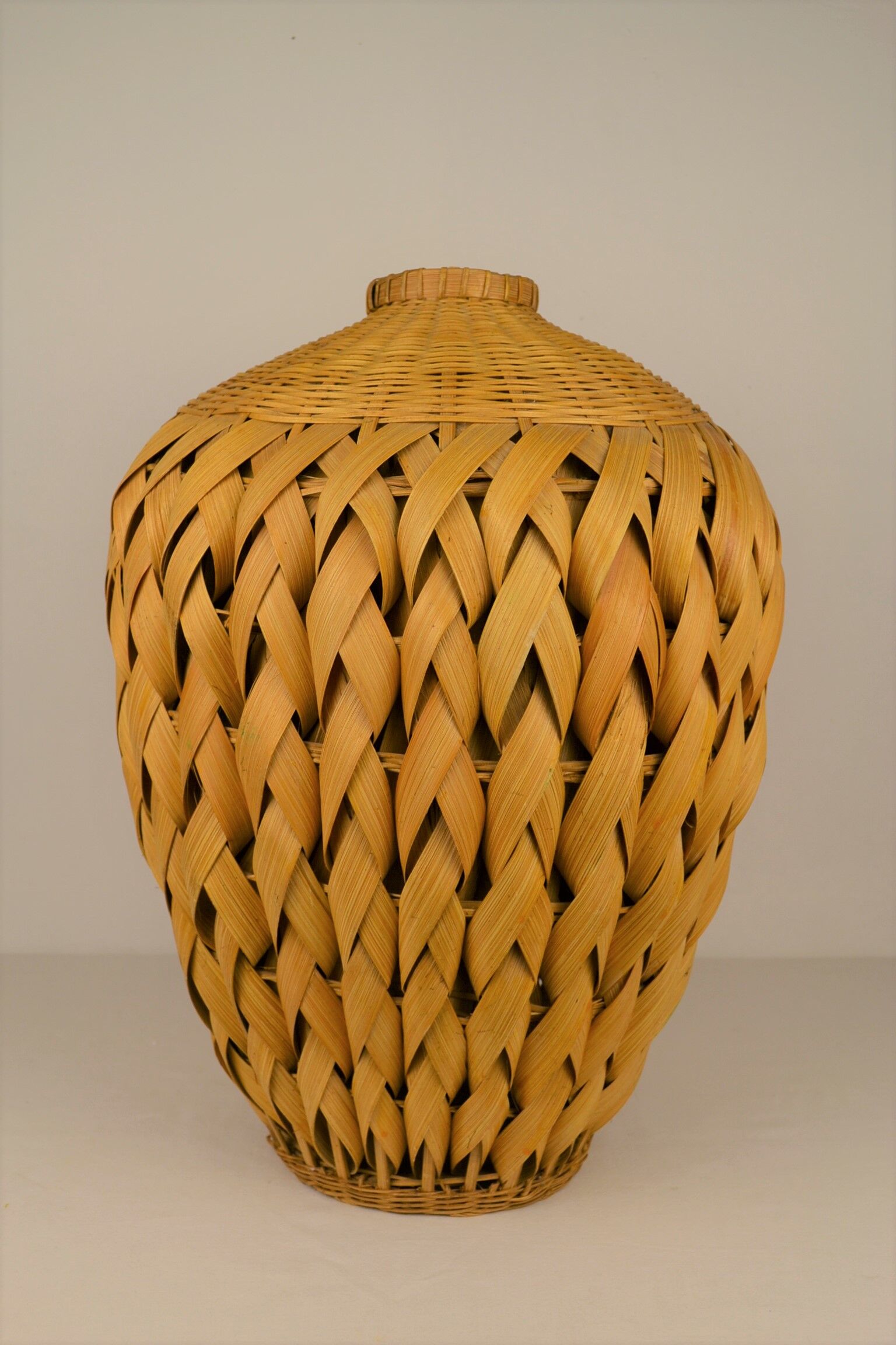 Rattan vase and braided bamboo leaves