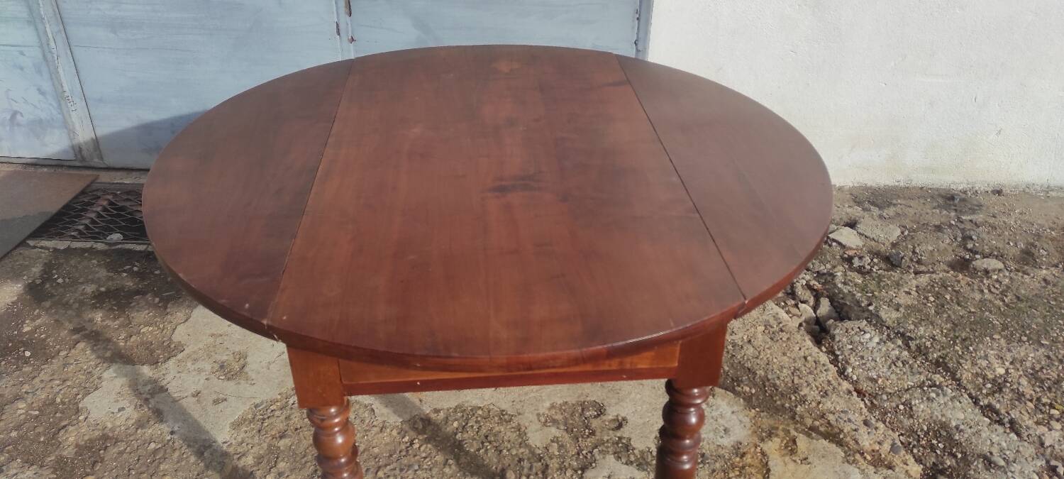 Old extendable round table in fruit wood with folding sides