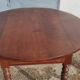 Table ronde ancienne extensible en bois fruitier avec côtés rabattables