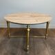 Brass coffee table with a white marble top.