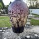 Acid-etched glass vase with a branch design.
