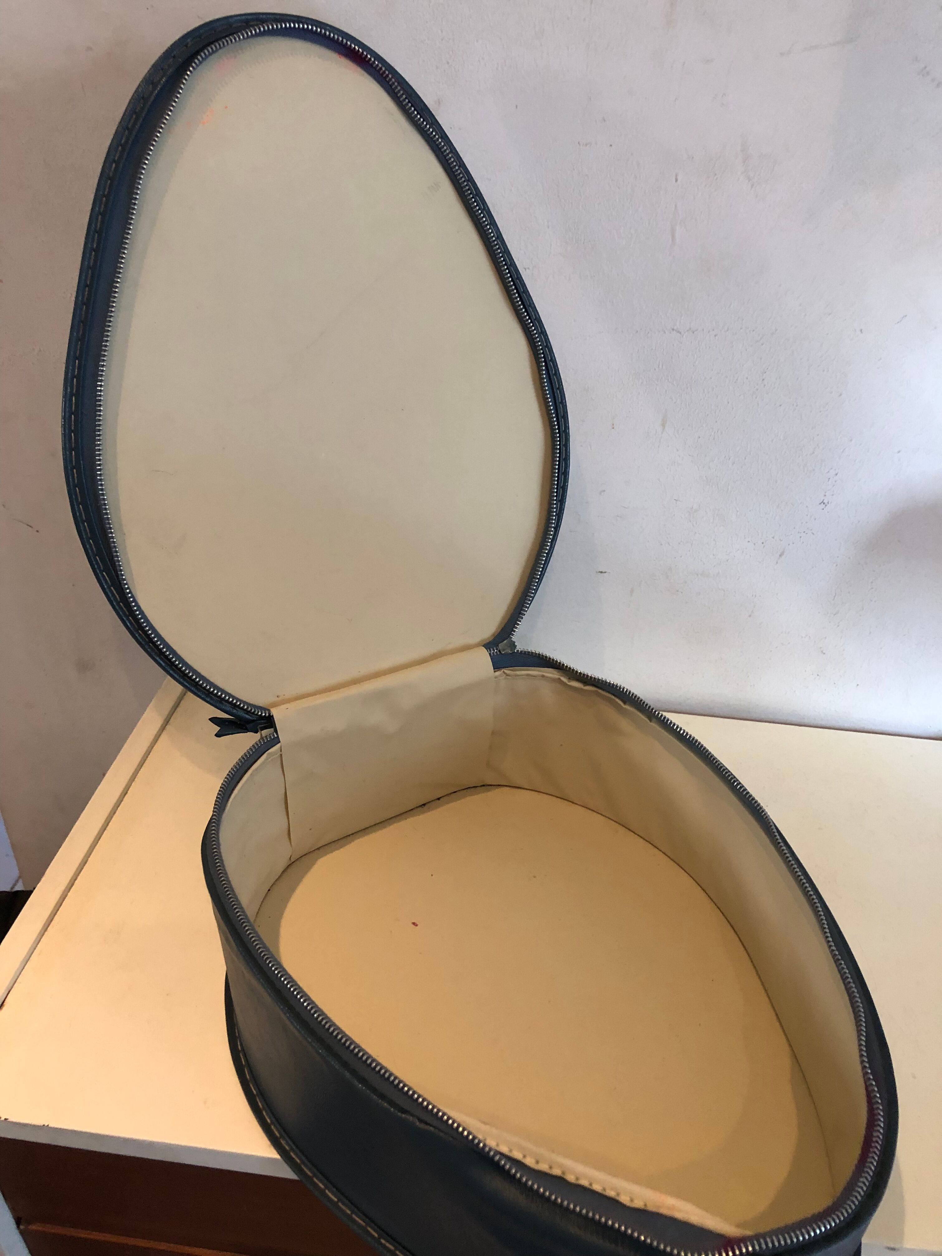 Suitcase has an air hostess hat