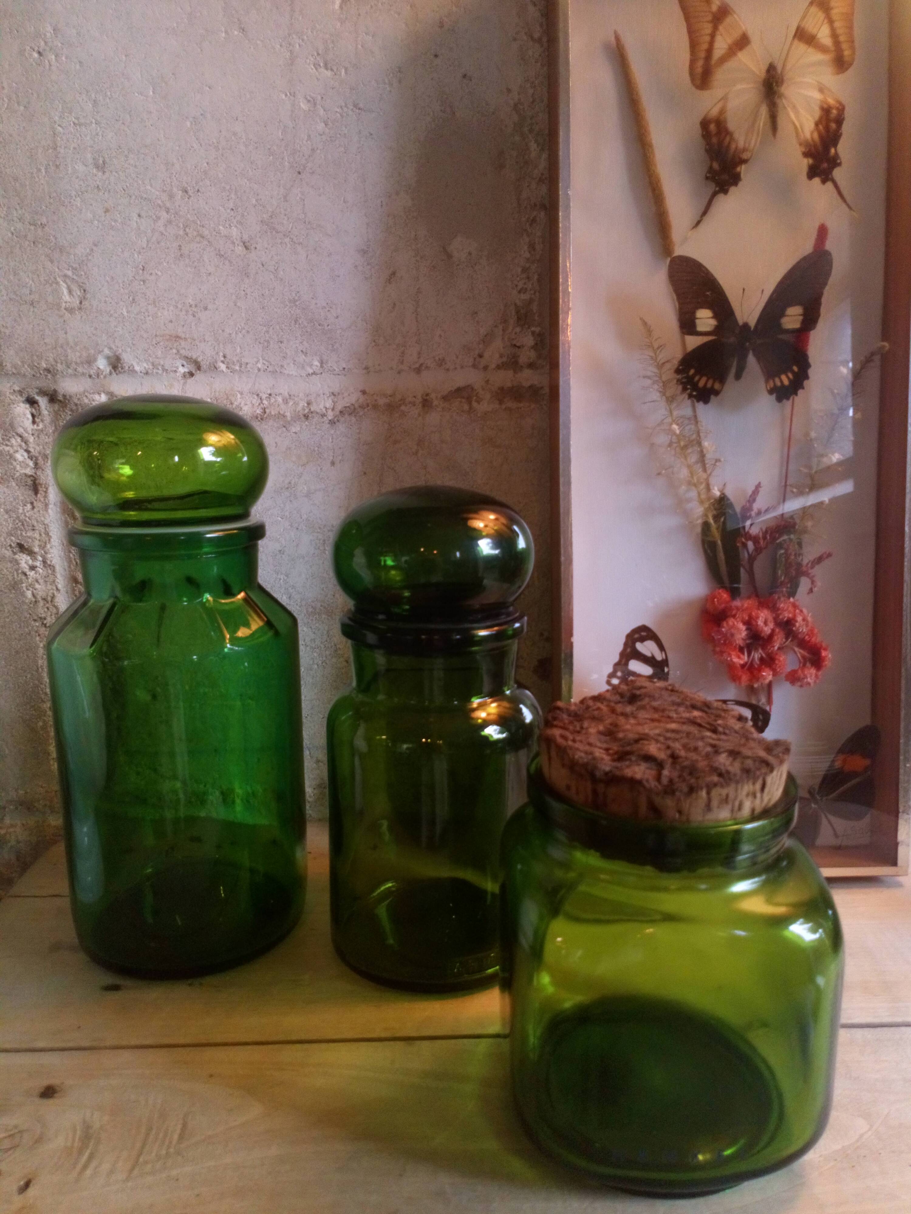 Trio of green glass apothecary bottles