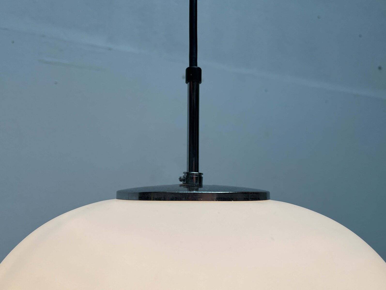 Minimalist suspended glass ball lamp from the vintage German space age by Glashütte Limburg, 1970s.