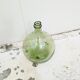 Give me a green glass jug made of blown glass.