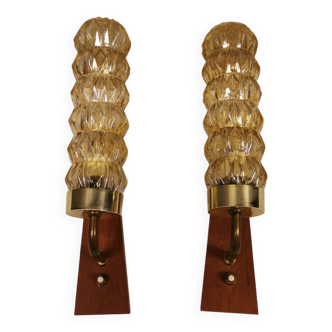 A set of Danish wall lights in champagne coloured glass with brass and teak.