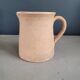 Antique milk jug in glazed terracotta