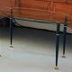 Table basse 1950 ovale en verre acier et laiton