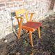 Old wooden and red leatherette bridge chair