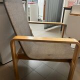 Armchair in curved wood and gray fabric