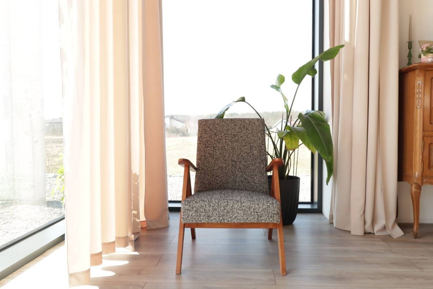 Vintage design armchair in mixed black fabric, walnut-coloured wood.