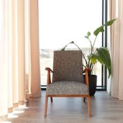 Vintage design armchair in mixed black fabric, walnut-coloured wood.