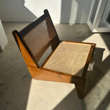 Reclined armchair in canned teak in natural wood