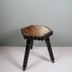 Vintage Spanish stool in carved wood with a leather seat.
