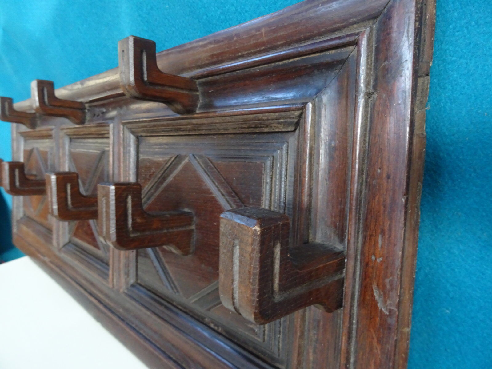 Wall-mounted coat rack in solid oak with 9 hooks.