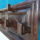 Wall-mounted coat rack in solid oak with 9 hooks.