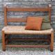 Wooden-backed bench with straw seat, 1970s.