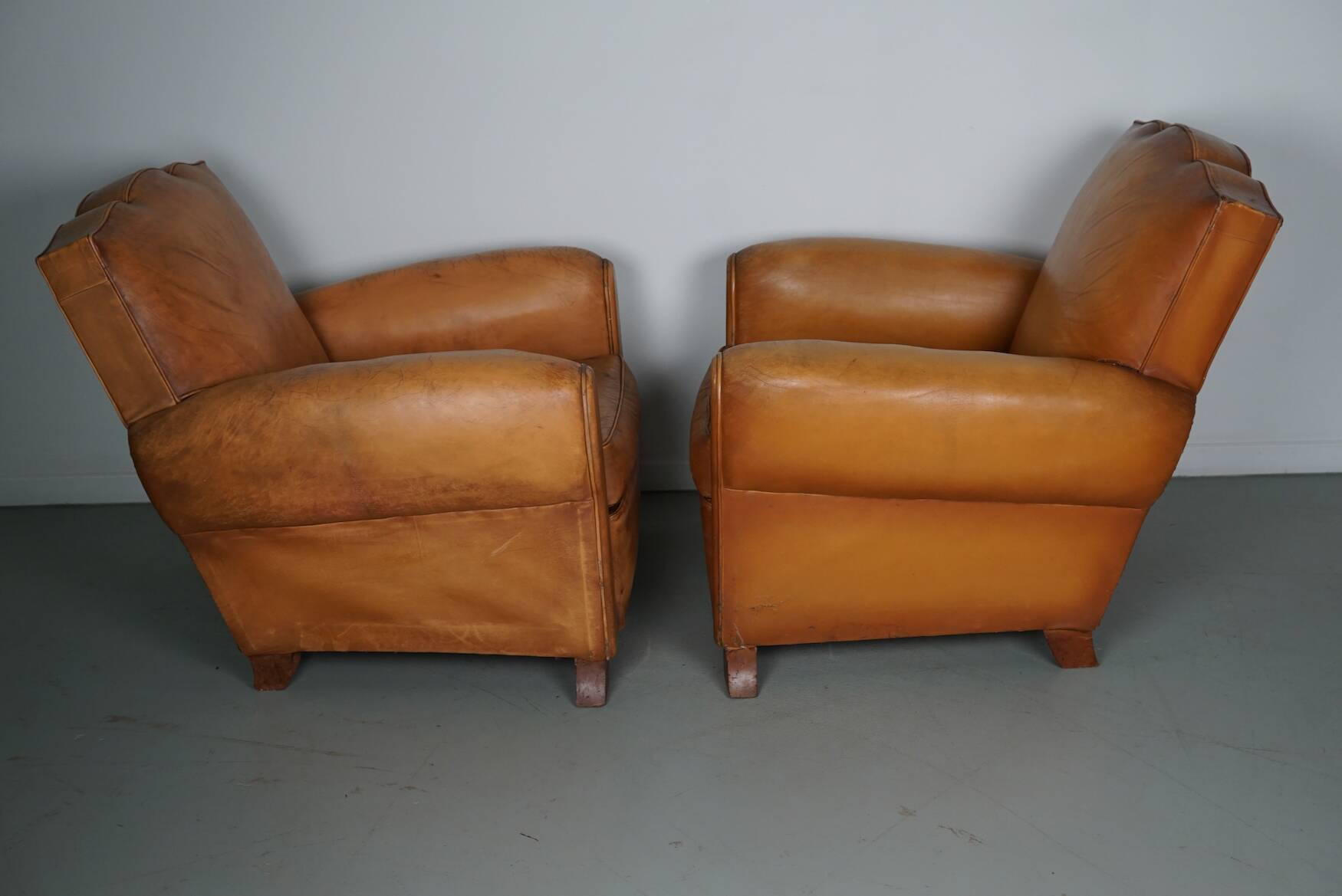 Pair of French Cognac Moustache Back Leather Club Chairs, 1950s