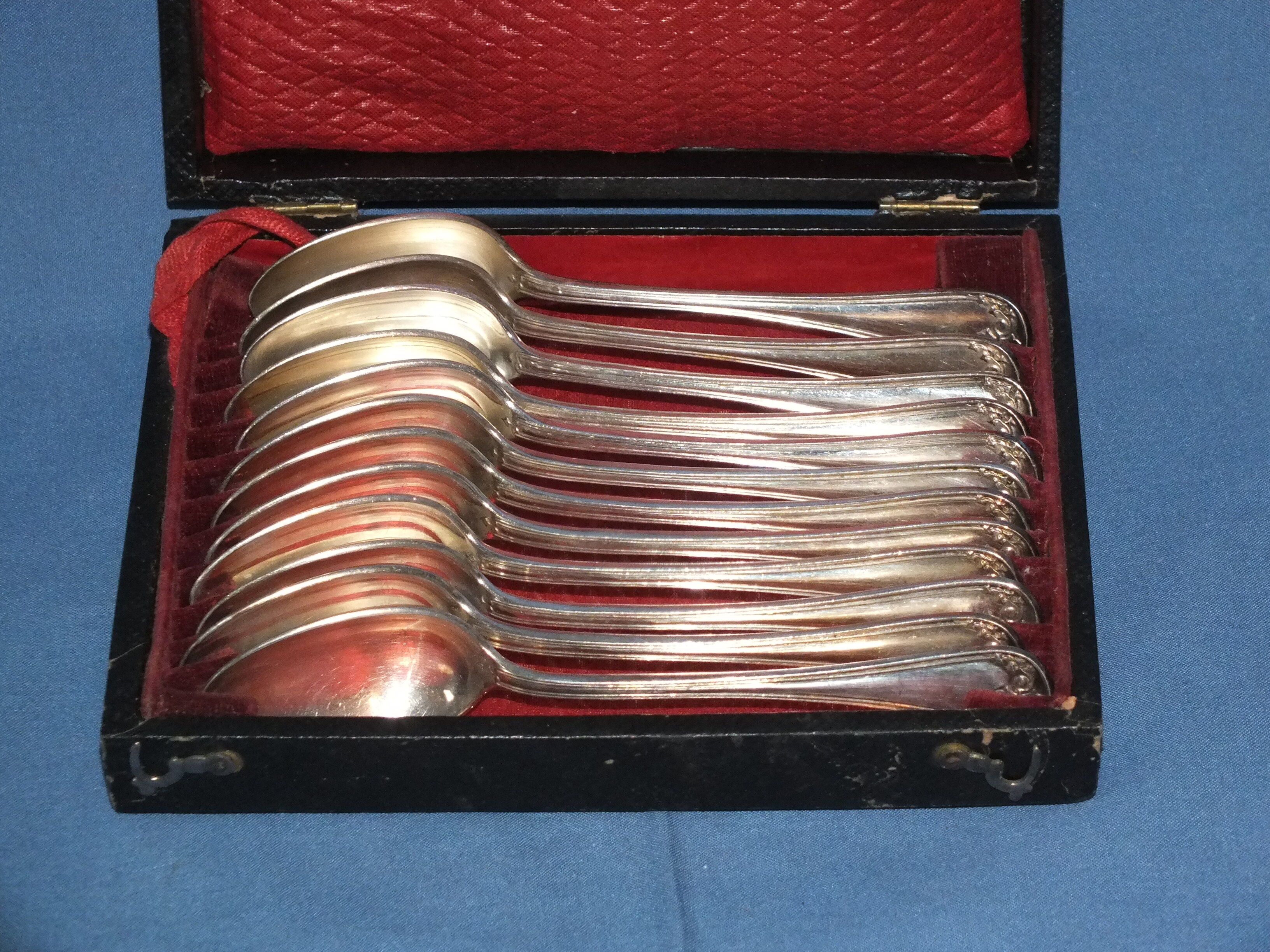 Old box of 12 small white metal spoons