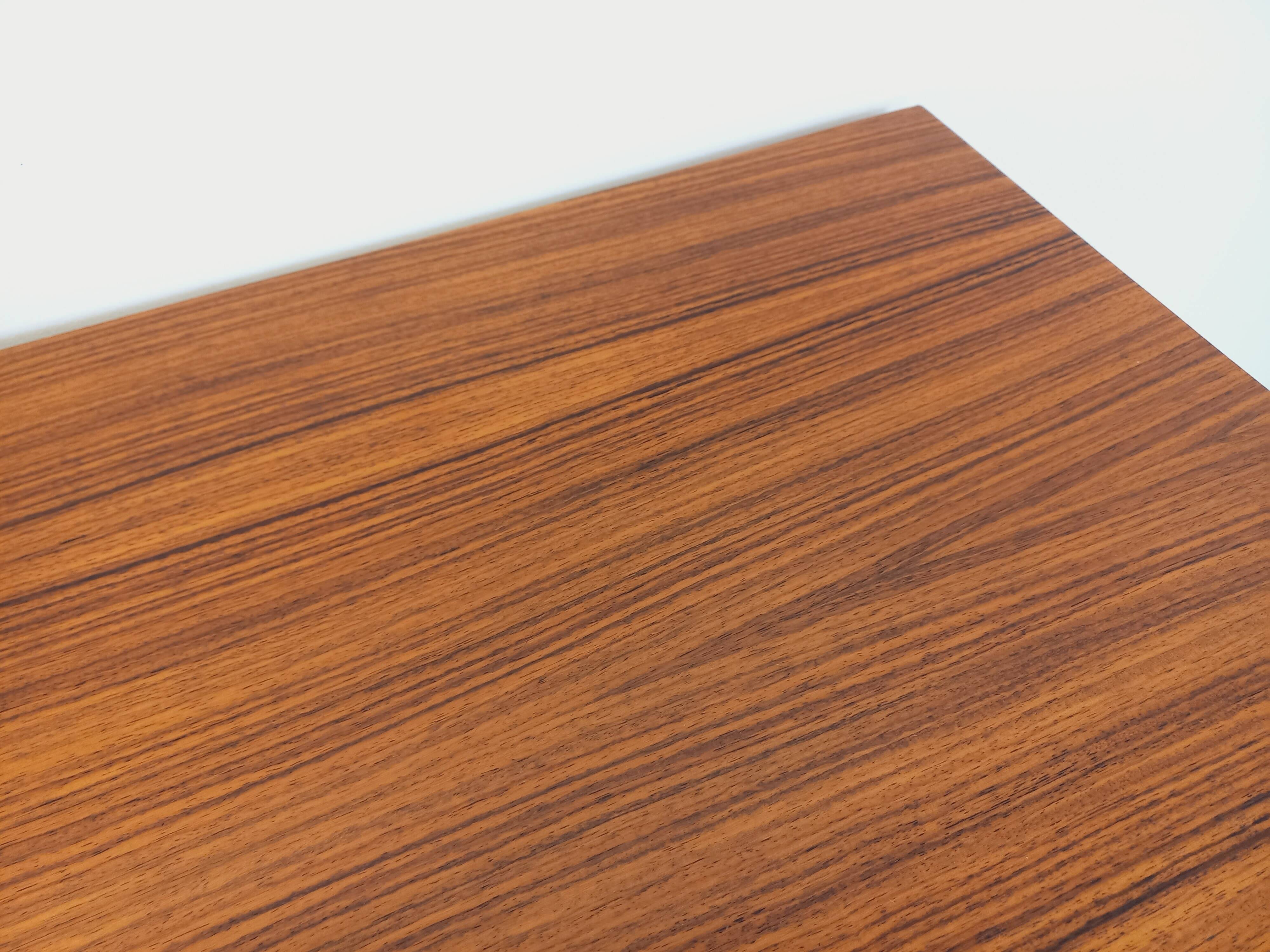 Vintage Scandinavian modernist chest of drawers in rosewood and black metal.