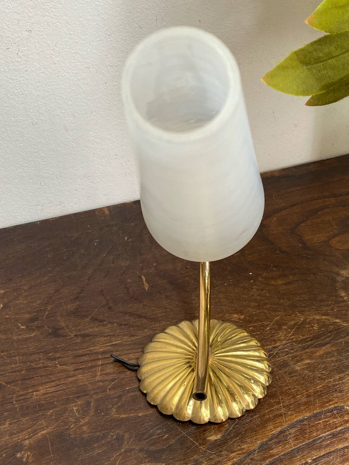 Gold metal wall light with ribbed glass.