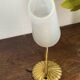 Gold metal wall light with ribbed glass.