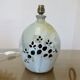 Ceramic lamp with double lighting and openwork design.