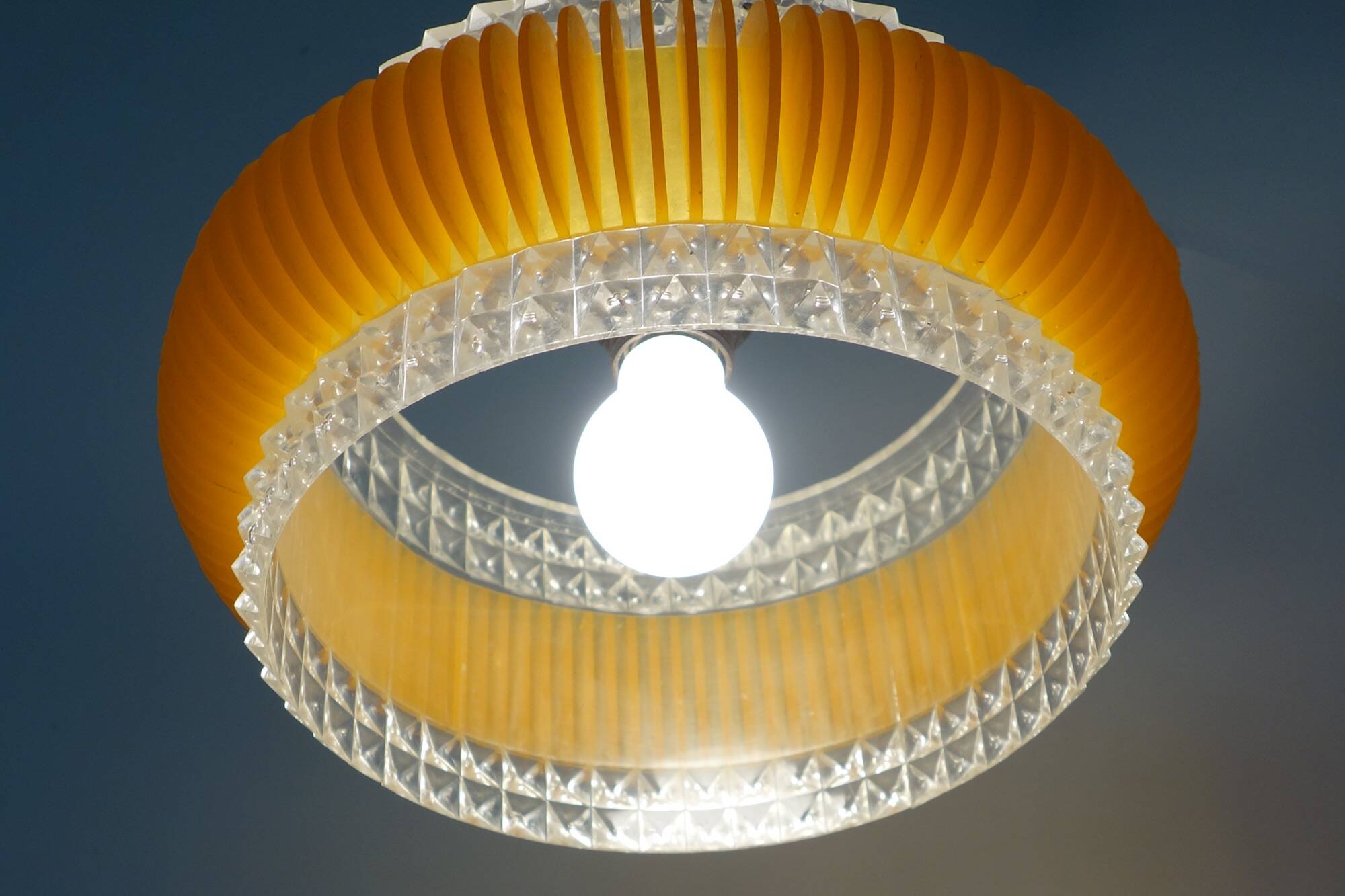 Transparent plastic space age lustre with orange band from the 70s.