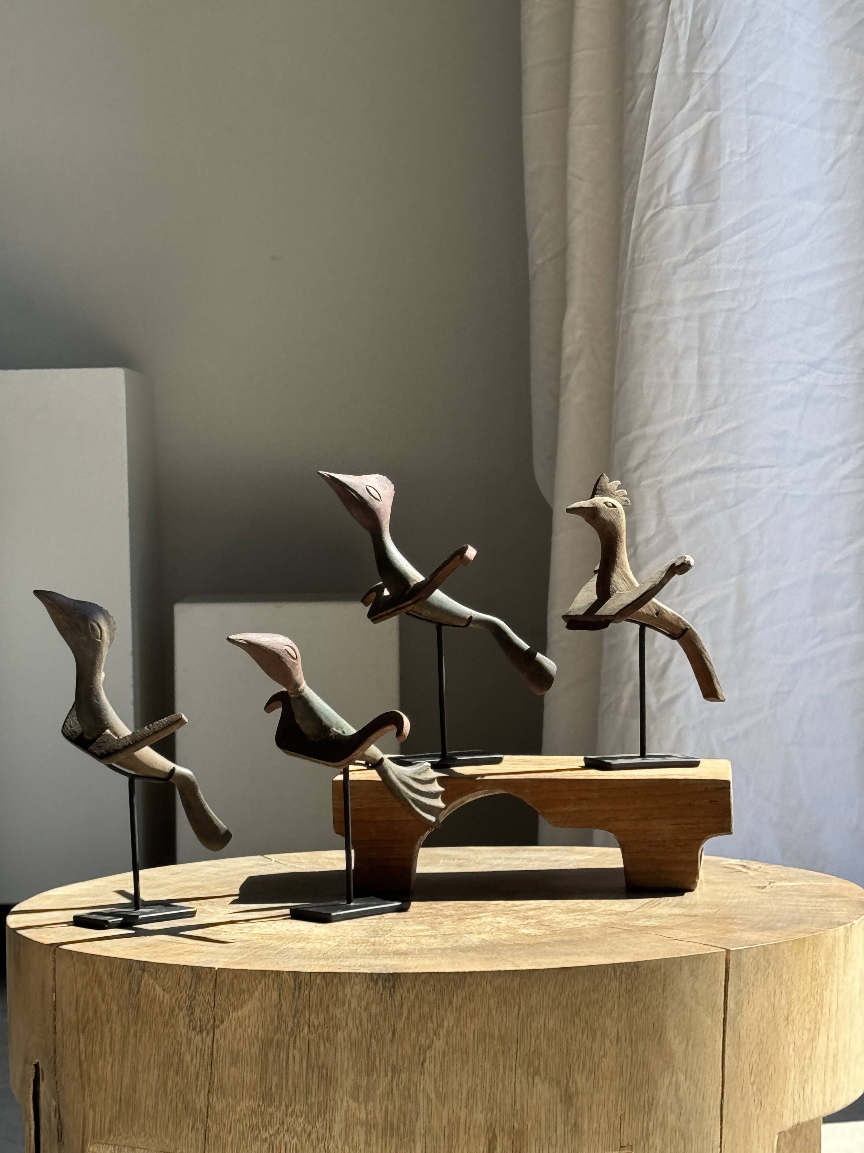 Traditional Indonesian decorative wooden bird on a base, crest model.