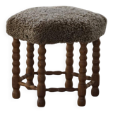 A hexagonal oak stool, seat refurbished in lambswool, Danish design from the 1950s.