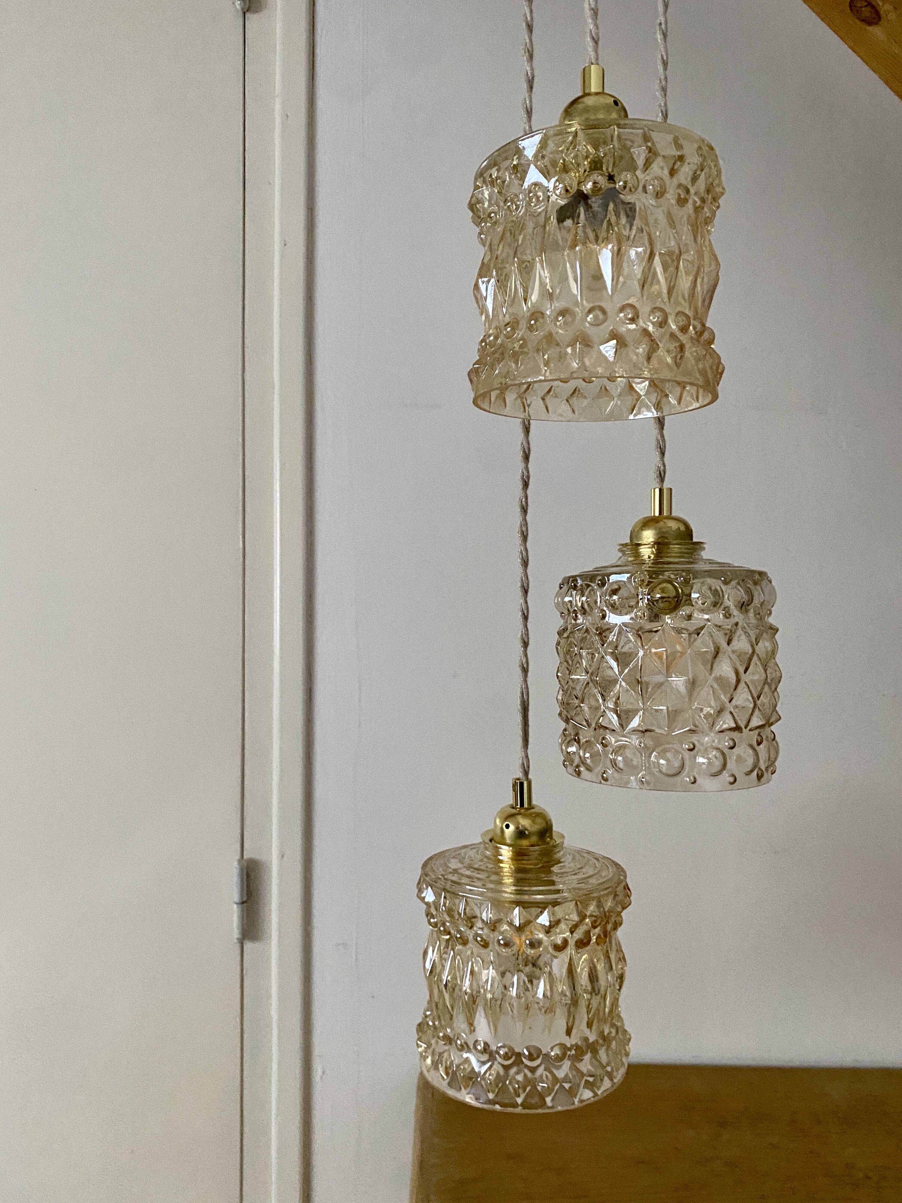 Triple antique globe pendant light in amber glass