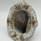 Antique porcelain mirror from Dresden with relief flowers and rococo decoration.