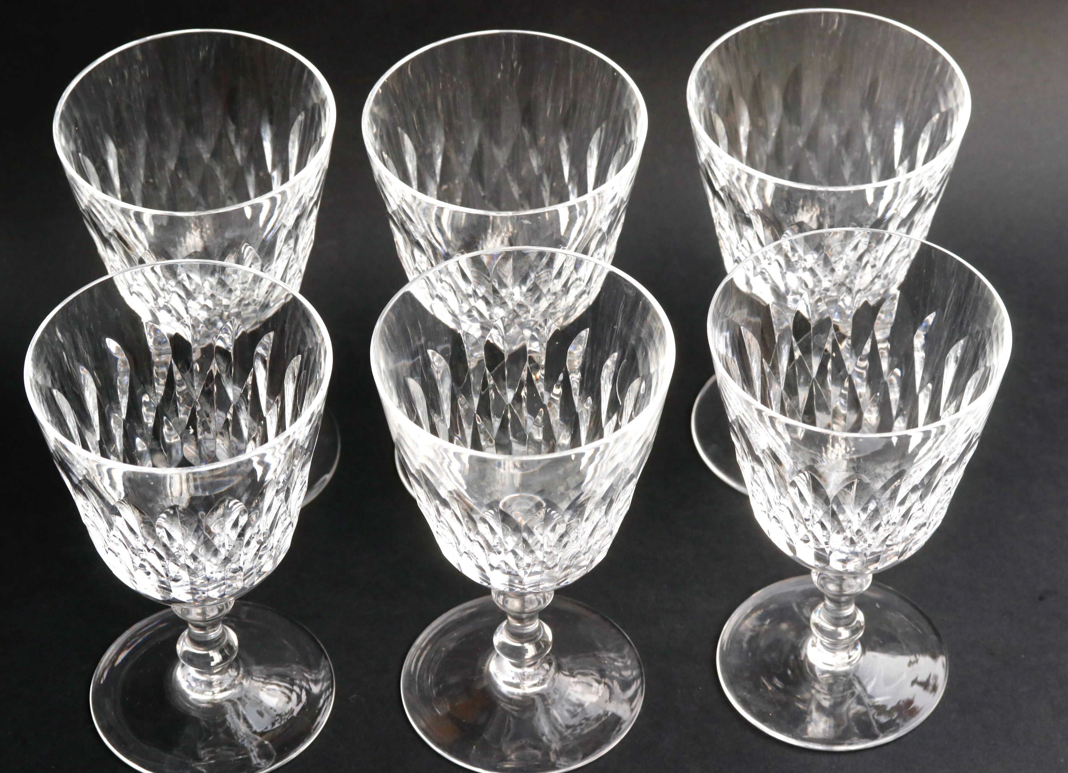 Suite of 6 Baccarat crystal water glasses with honeycomb patterns.