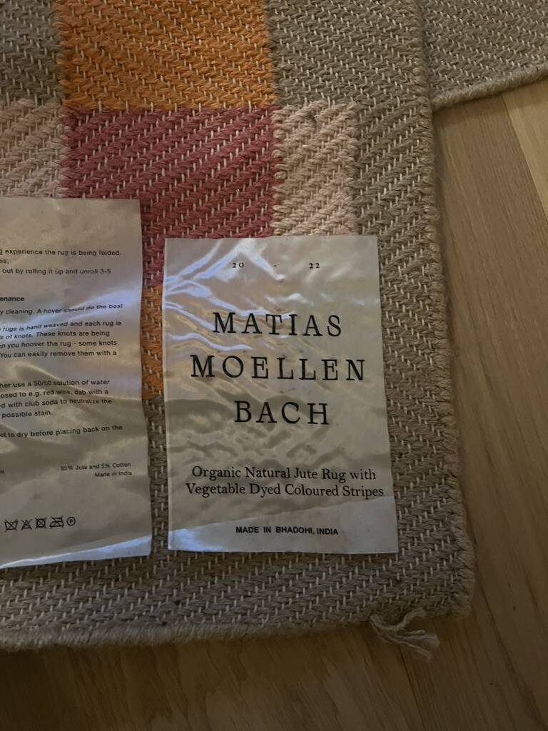 Organic jute rug with orange and pink patterns by Matias Mollenbach