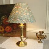 Brass candlestick lamp with its fabric lampshade by William Morris