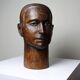 Monoxyle wood sculpture of a man's head, vintage craftsmanship from the 1950s.
