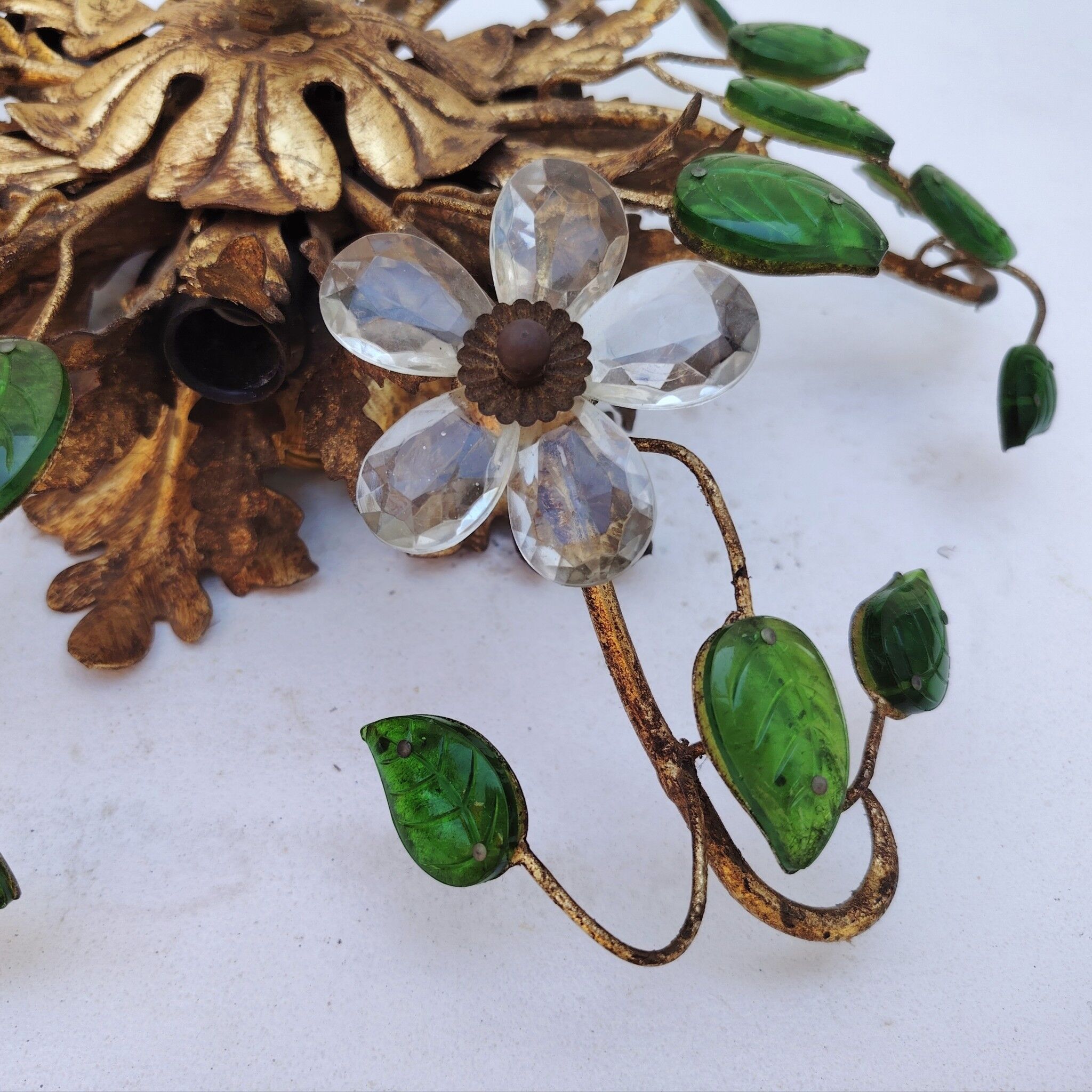 Flower wall light, gilded metal and glass cabochons, attributed to Baguès.