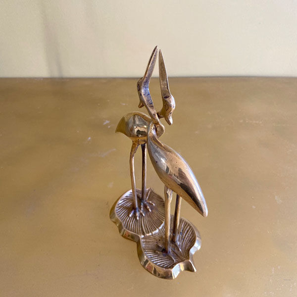 Couple of brass intertwined herons