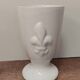 Three antique cups decorated with fleur-de-lis.