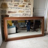 Large bevelled tabletop mirror in carved gilded wood.