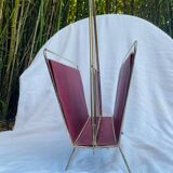 Vintage magazine rack in red skai with gold metal frame and plastic handle